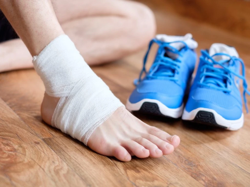man with his injured sprained ankle 