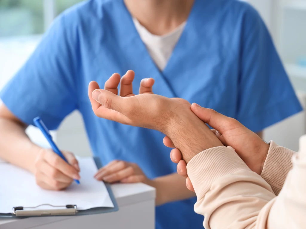 Doctor examining a patient with hand and wrist pain