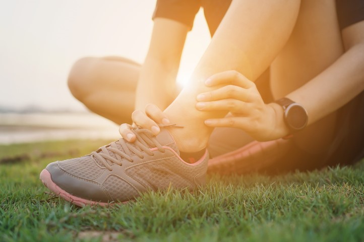 Ankle twist sprain accident in sport exercise running jogging.sprain or cramp Overtrained injured person when training exercising or running outdoors.