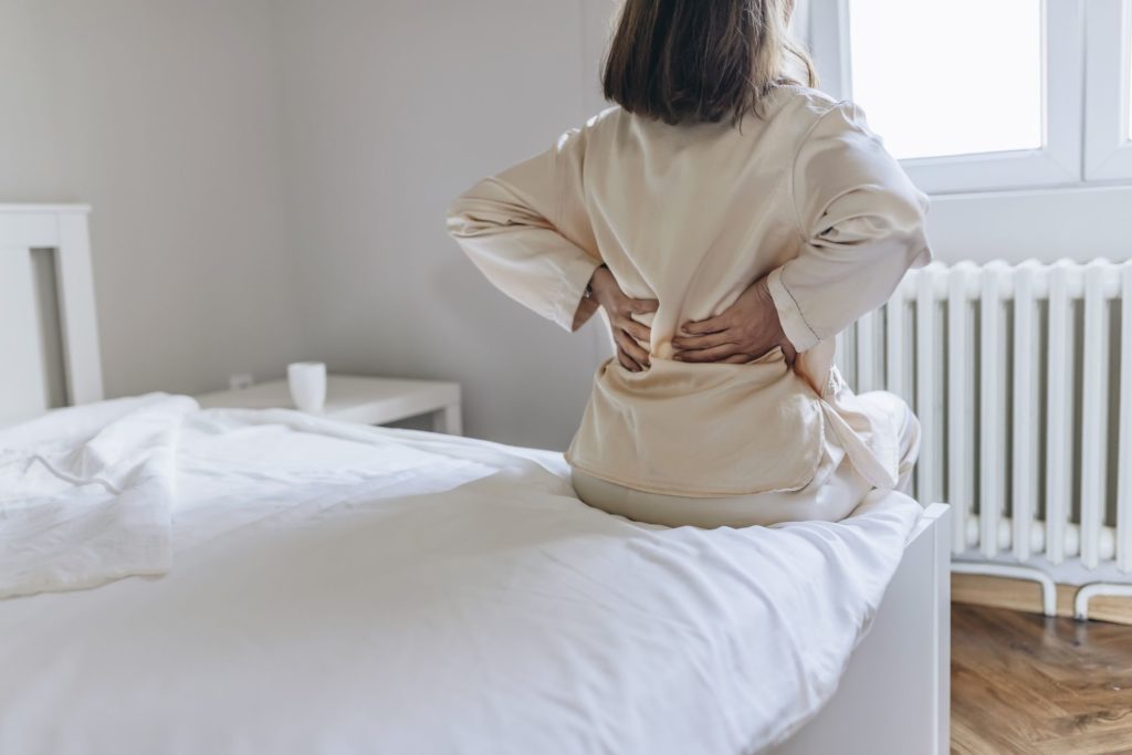 woman back pain home